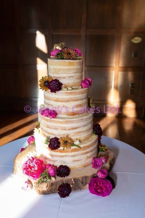 Four tier Semi Naked Wedding Cake with fresh flowers